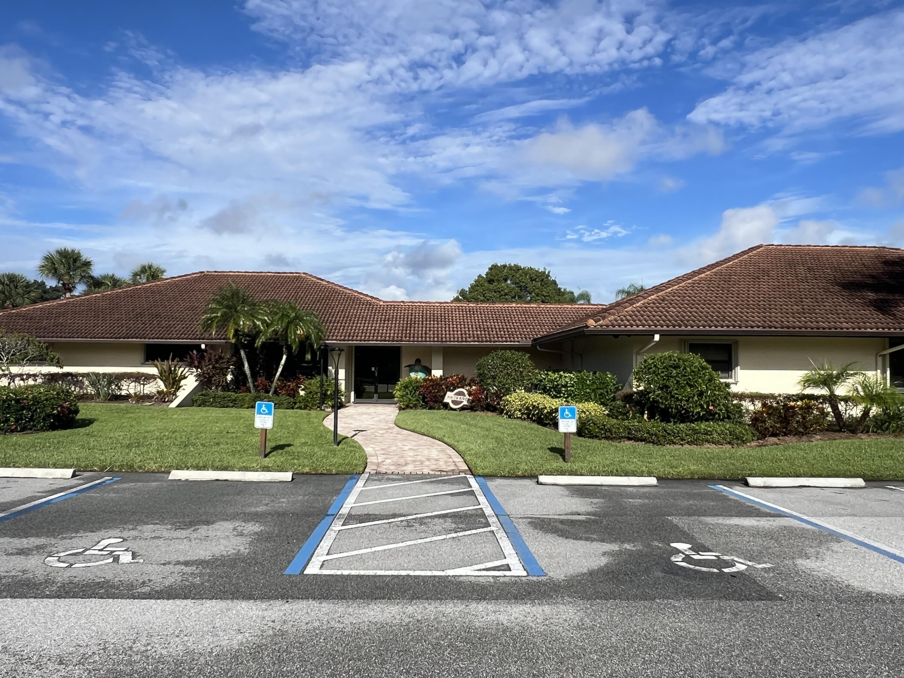 151 Southwest South River Drive, Unit 203 Stuart, FL 34997 - Photo 40 of 54 a front view of house with a yard