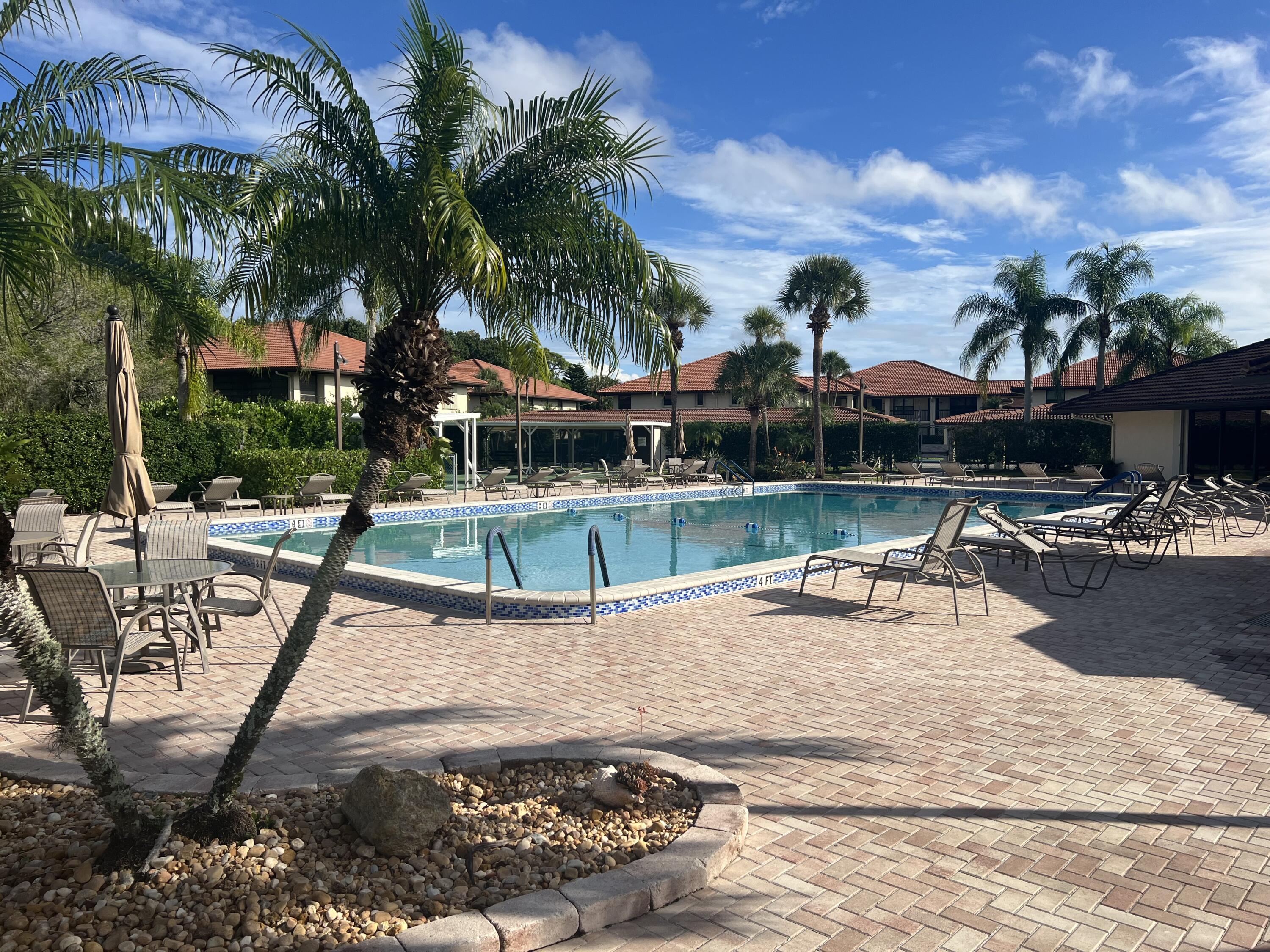151 Southwest South River Drive, Unit 203 Stuart, FL 34997 - Photo 42 of 54 a view of a swimming pool with a patio and a yard