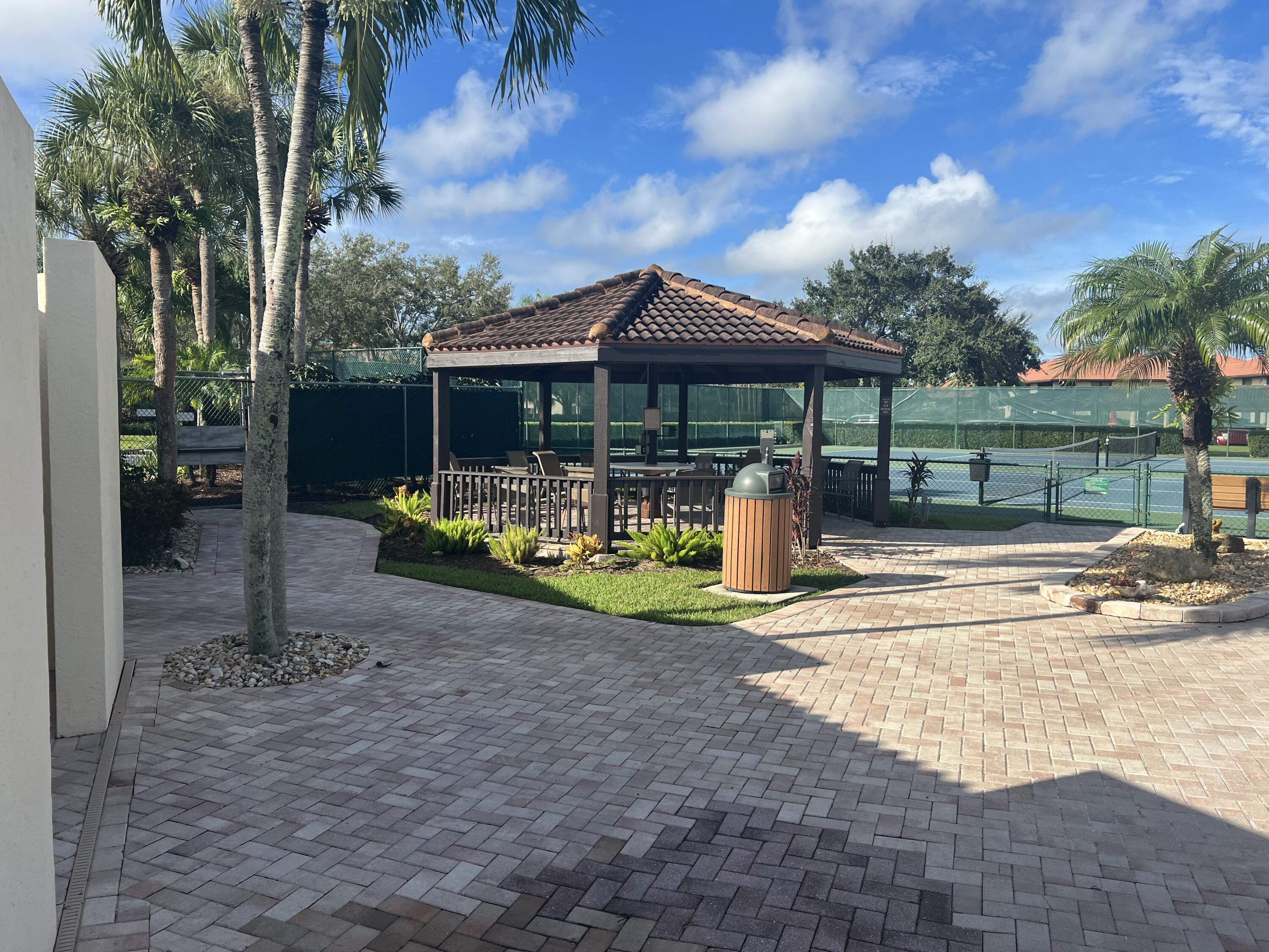 151 Southwest South River Drive, Unit 203 Stuart, FL 34997 - Photo 44 of 54 a view of a house with backyard outdoor seating area and furniture