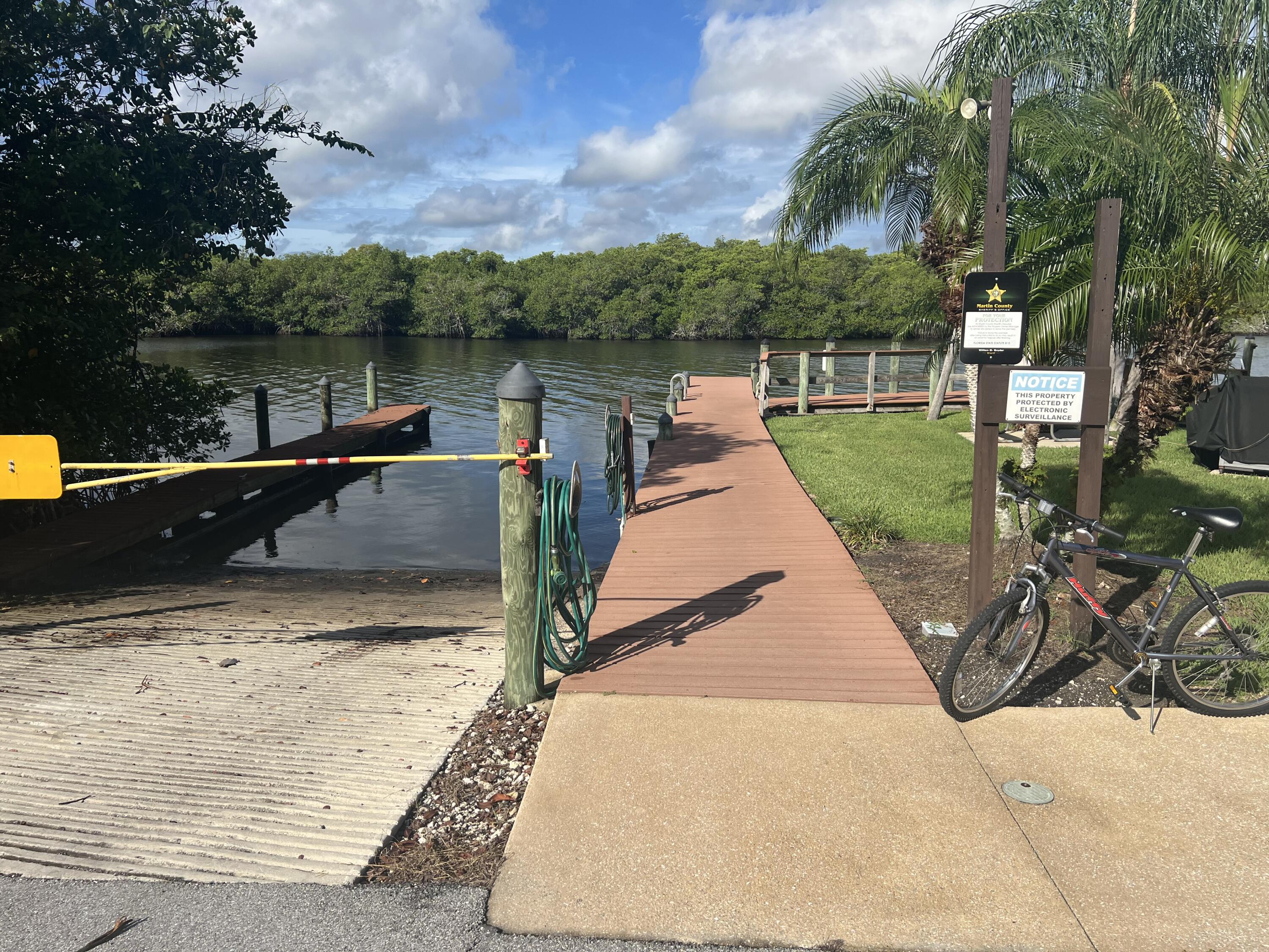 151 Southwest South River Drive, Unit 203 Stuart, FL 34997 - Photo 48 of 54 a view of a lake with a floor to ceiling window next to a yard