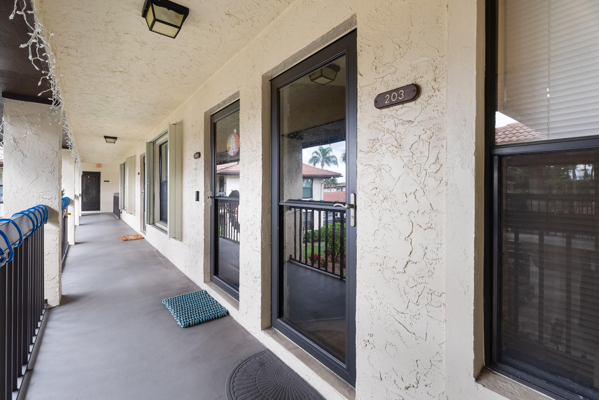 151 Southwest South River Drive, Unit 203 Stuart, FL 34997 - Photo 7 of 54 a hallway with a door and a view of living room