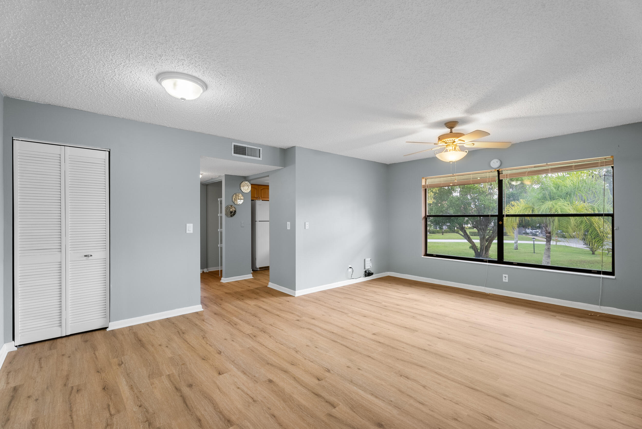 151 Southwest South River Drive, Unit 203 Stuart, FL 34997 - Photo 8 of 54 a view of an empty room with a window and wooden floor