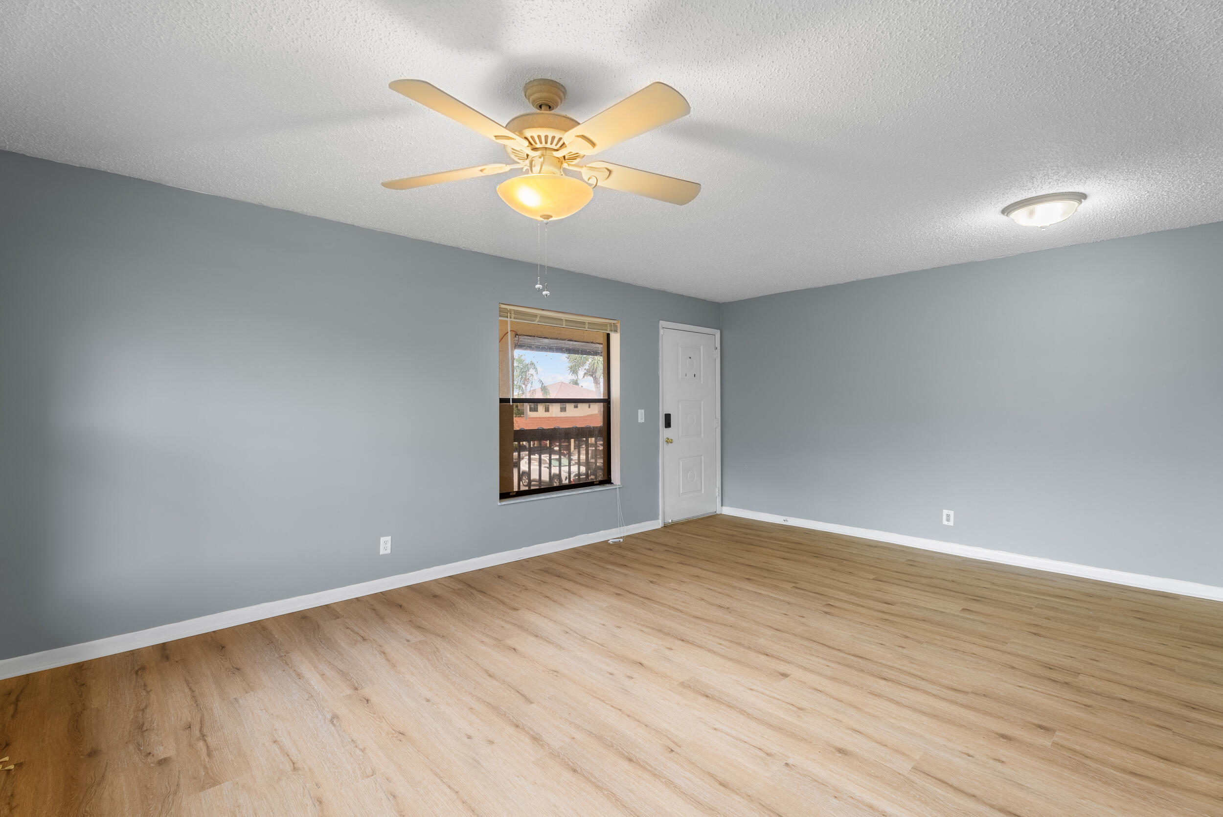 151 Southwest South River Drive, Unit 203 Stuart, FL 34997 - Photo 9 of 54 wooden floor in an empty room with a window