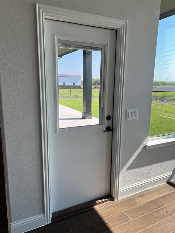 2108 Charters Circle Nevada, TX 75173 - Photo 30 of 37 Entryway featuring a textured wall and wood finish floors