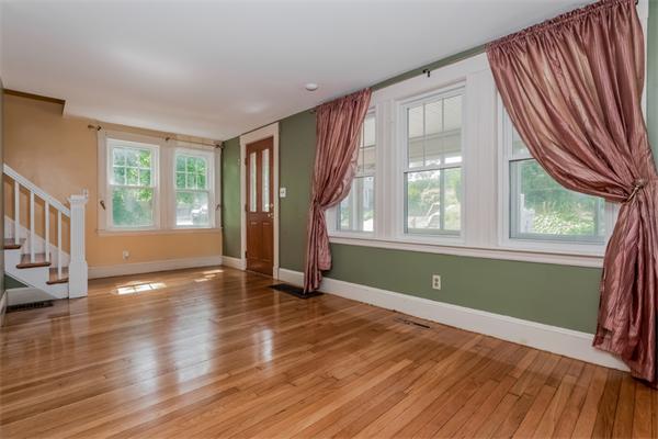 15 Volusia Road Hingham, MA 02043 - Photo 5 of 22 a view of an empty room with wooden floor and a window
