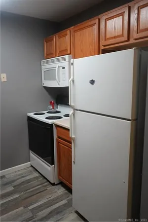 a white refrigerator freezer sitting inside of a kitchen