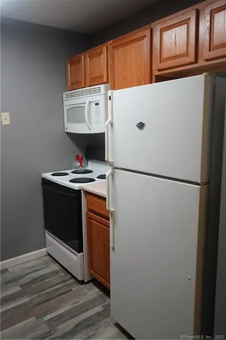 a white refrigerator freezer sitting inside of a kitchen