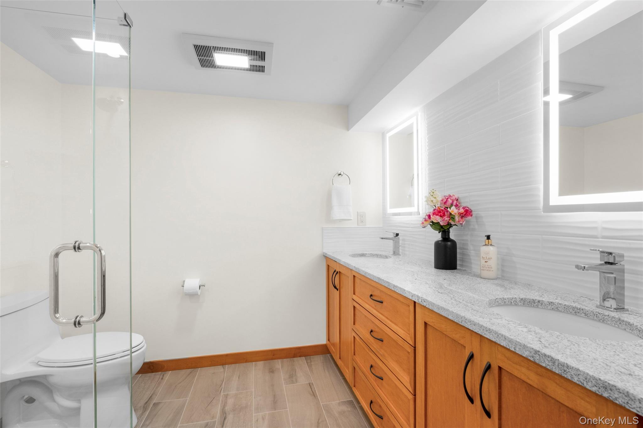 14 Ridgeland Terrace Rye, NY 10580 - Photo 25 of 37 Lower level bath with double vanity and walk-in shower
