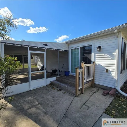 a view of a house with wooden floor and a fence