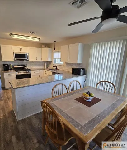 a kitchen with a table chairs stove and microwave