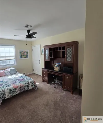 a bedroom with bed and a window