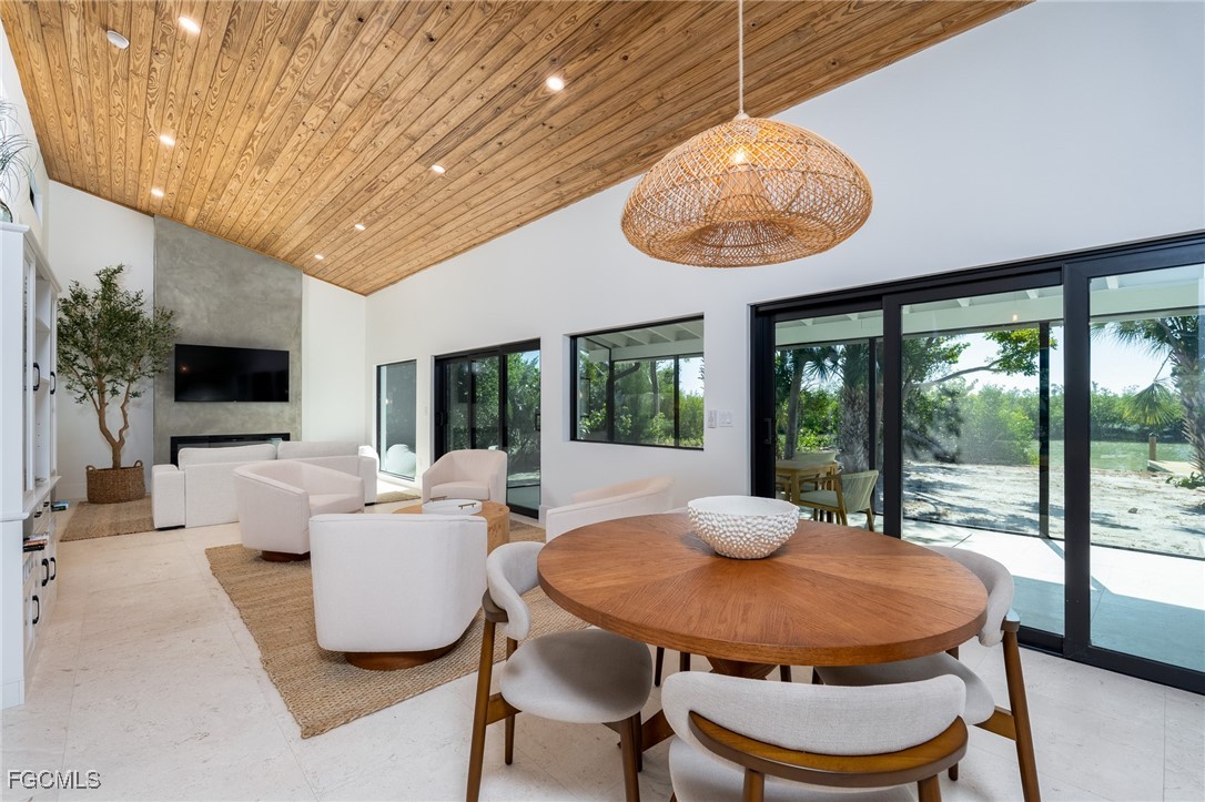 5801 Sanibel Captiva Road Sanibel, FL 33957 - Photo 17 of 45 a living room with furniture a flat screen tv and a large window