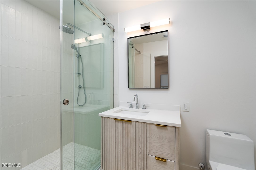 5801 Sanibel Captiva Road Sanibel, FL 33957 - Photo 28 of 45 a bathroom with a sink a toilet and shower