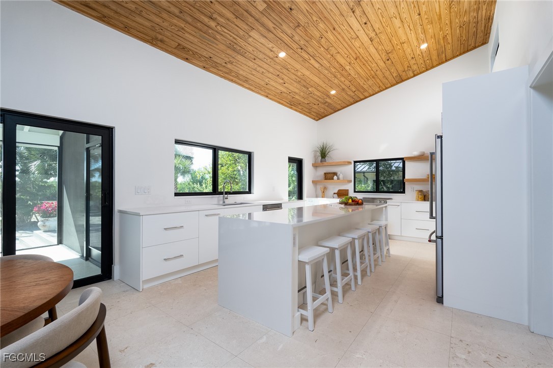 5801 Sanibel Captiva Road Sanibel, FL 33957 - Photo 31 of 45 a large white kitchen with a large window