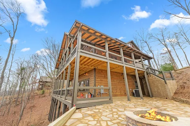 a kitchen with granite countertop a sink chairs and cabinets