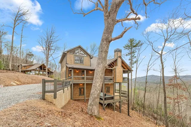 a spacious bedroom with a bed and a chandelier