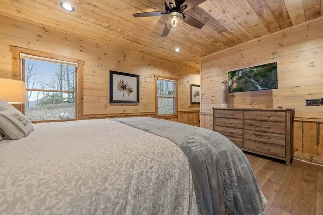 a spacious bedroom with a bed a dresser and a walk in closet