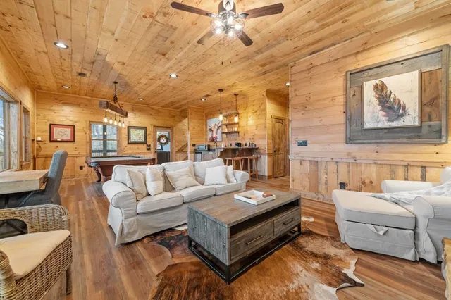 a room with pool table and wooden floor