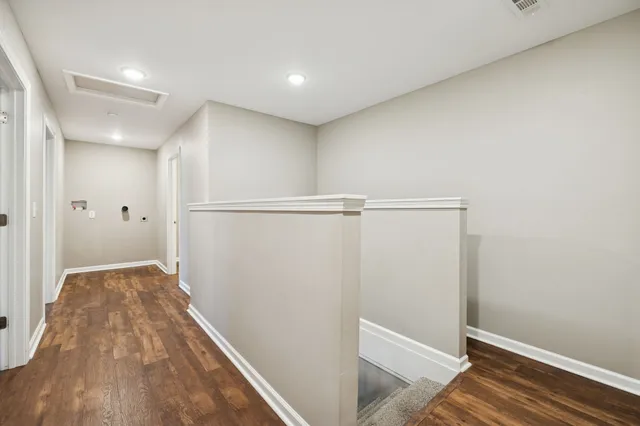 a view of hallway with wooden floor
