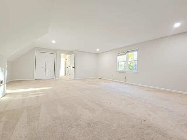 an empty room with a empty space and windows