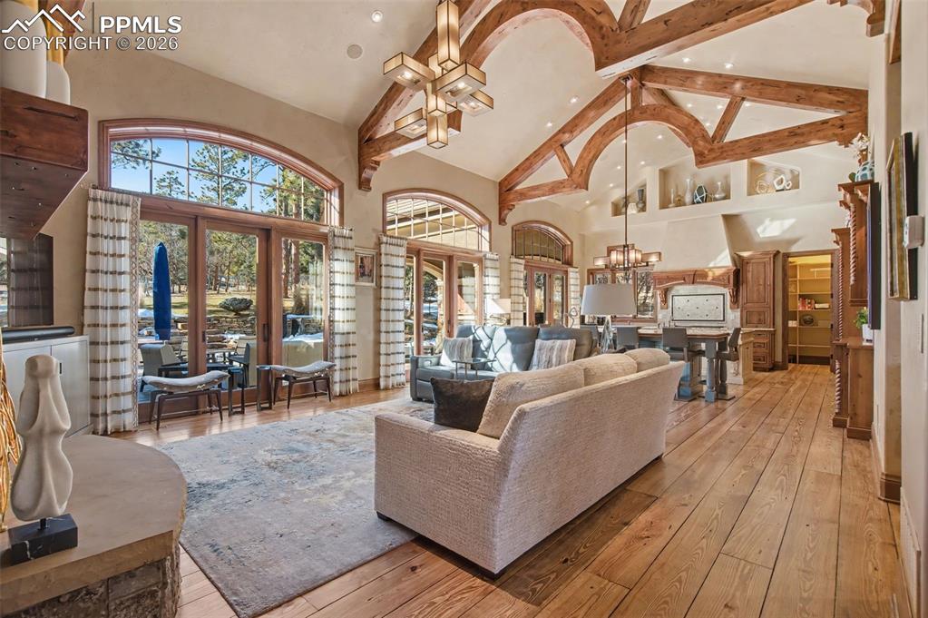 1830 Brantfeather Grove Colorado Springs, CO 80906 - Photo 14 of 50 a living room with furniture a chandelier and large windows