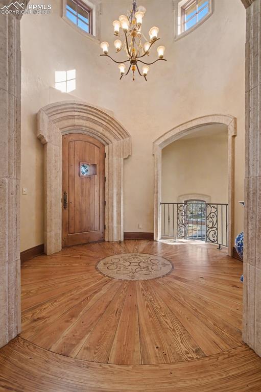 1830 Brantfeather Grove Colorado Springs, CO 80906 - Photo 17 of 50 a view of an empty room with a chandelier fan and a rug