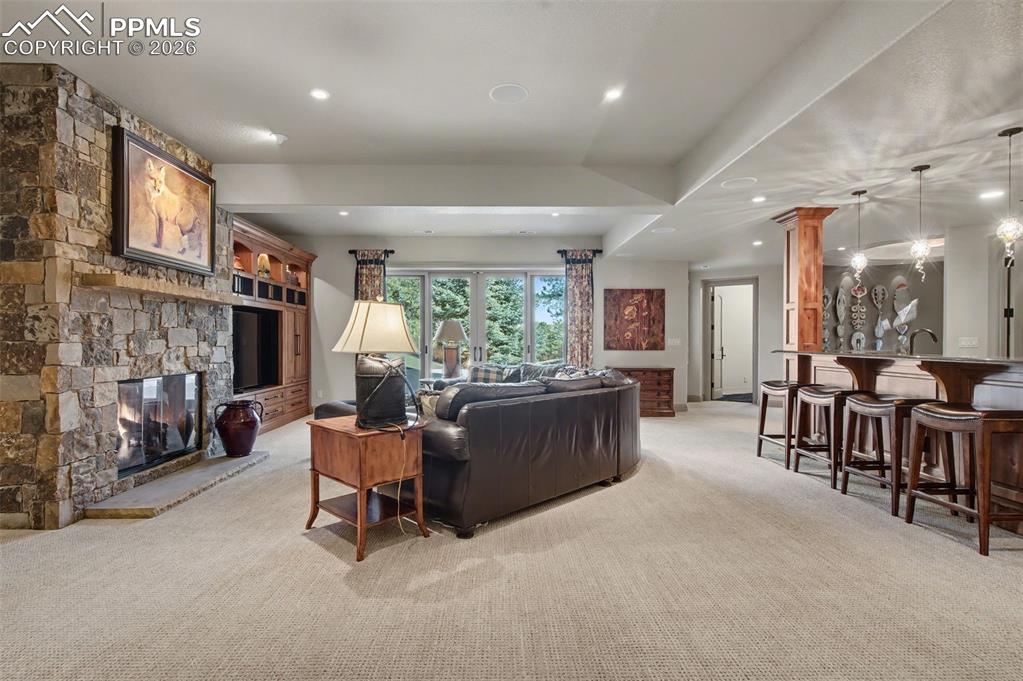 1830 Brantfeather Grove Colorado Springs, CO 80906 - Photo 32 of 50 a living room with furniture and a fireplace