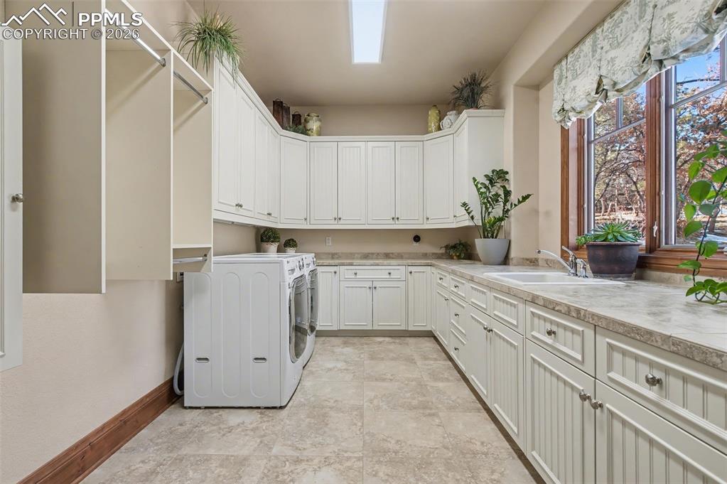 1830 Brantfeather Grove Colorado Springs, CO 80906 - Photo 34 of 50 a kitchen with white cabinets and white appliances