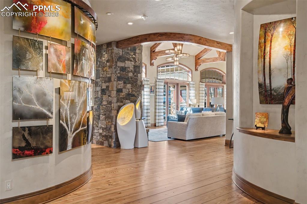 1830 Brantfeather Grove Colorado Springs, CO 80906 - Photo 6 of 50 a living room with couches a flat screen tv and kitchen view with wooden floor