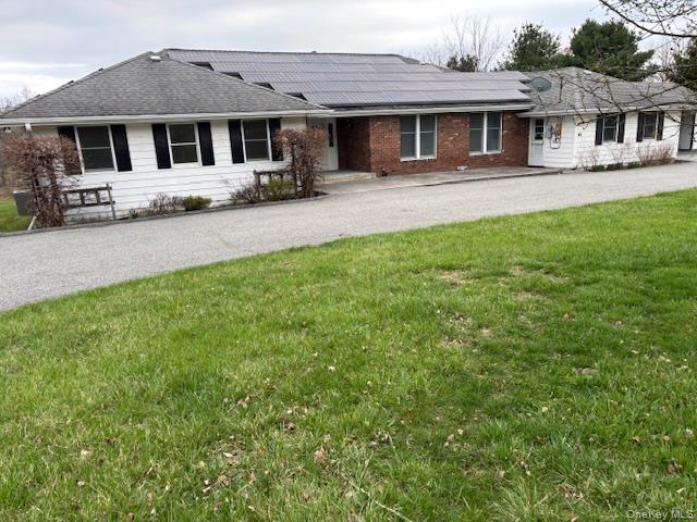 a front view of a house with a yard and porch