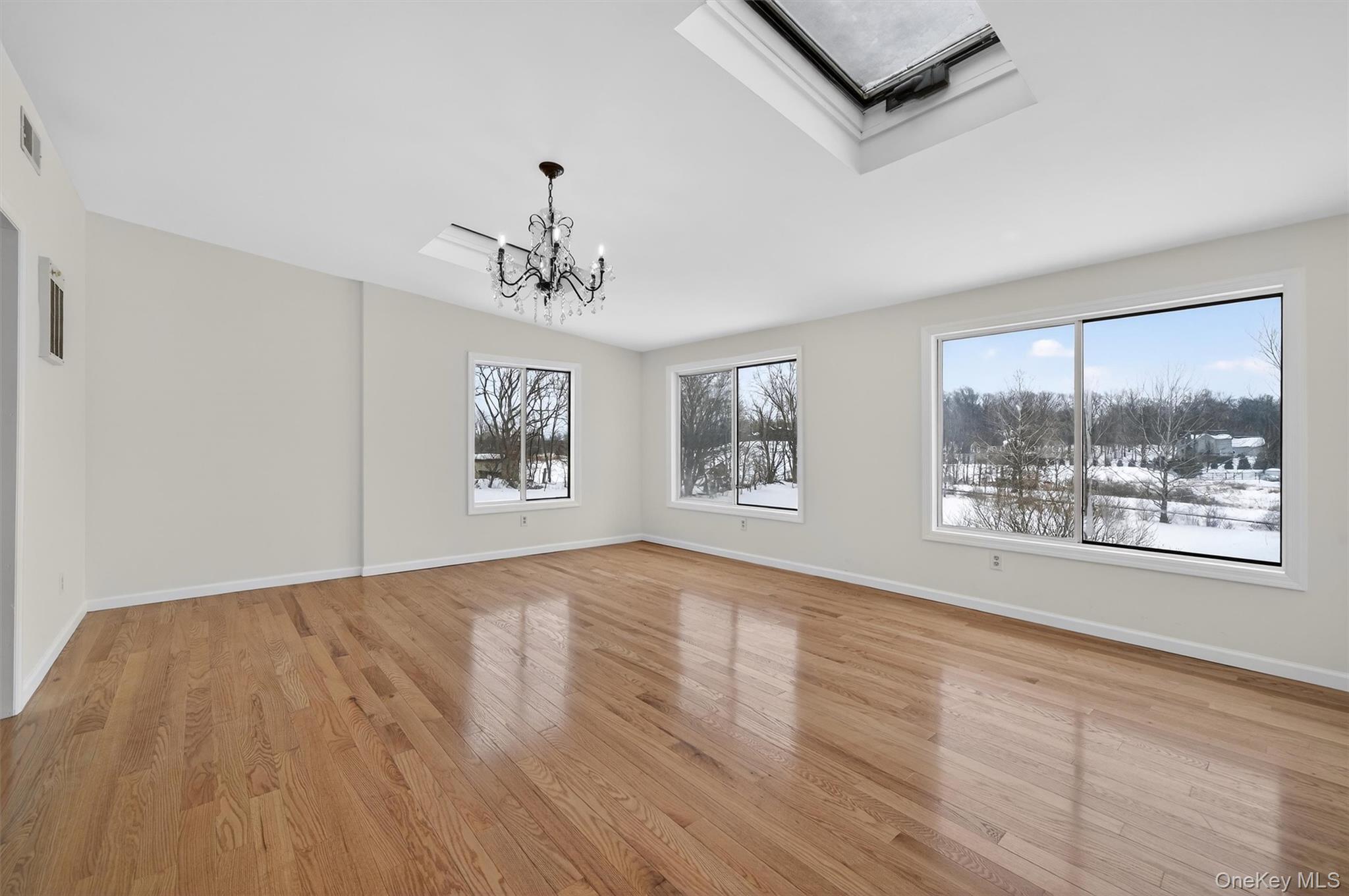 420 South Plank Road Westtown, NY 10998 - Photo 11 of 26 a view of an empty room with a window and wooden floor
