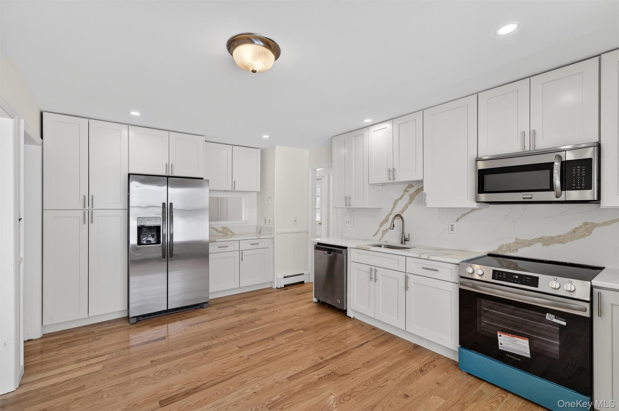420 South Plank Road Westtown, NY 10998 - Photo 4 of 26 a kitchen with granite countertop a refrigerator stove and microwave