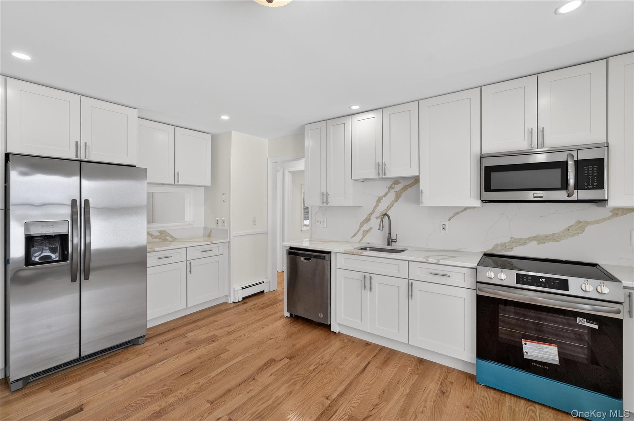 420 South Plank Road Westtown, NY 10998 - Photo 5 of 26 a kitchen with stainless steel appliances a stove a sink and a refrigerator