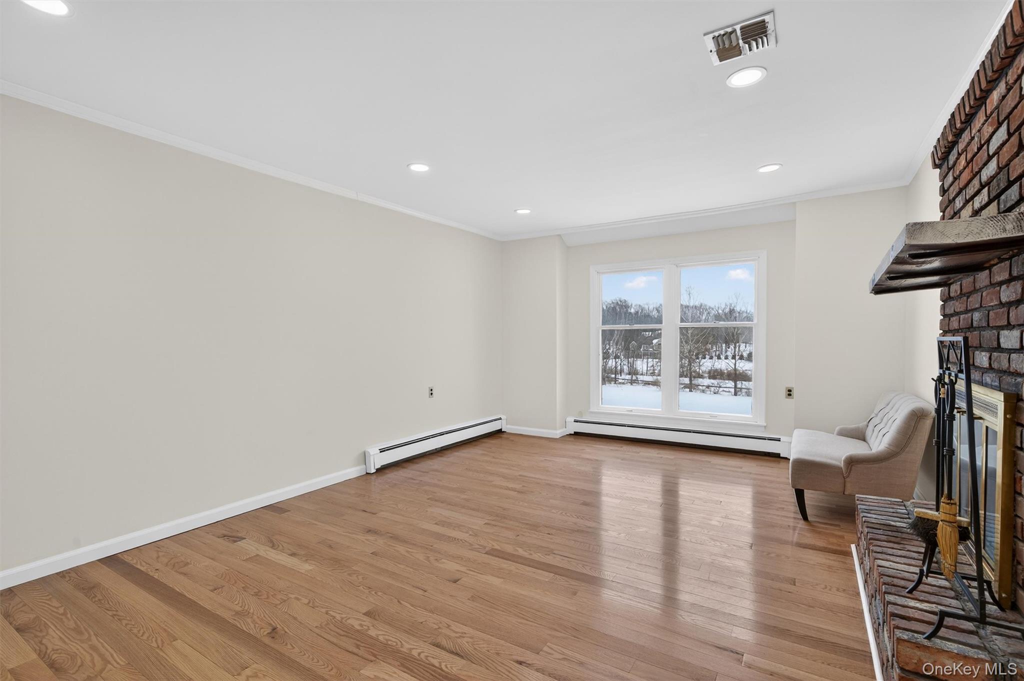 420 South Plank Road Westtown, NY 10998 - Photo 7 of 26 a view of an empty room with a window and wooden floor