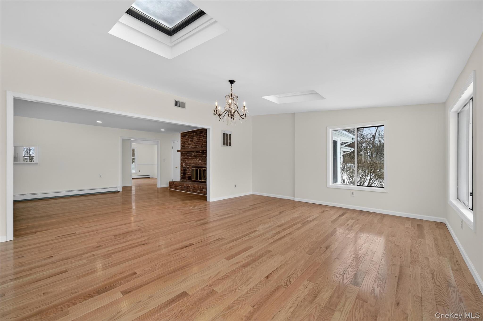 420 South Plank Road Westtown, NY 10998 - Photo 10 of 26 a view of an empty room with wooden floor and a window