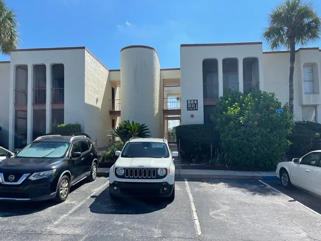 a building outdoor space with patio furniture and potted plants