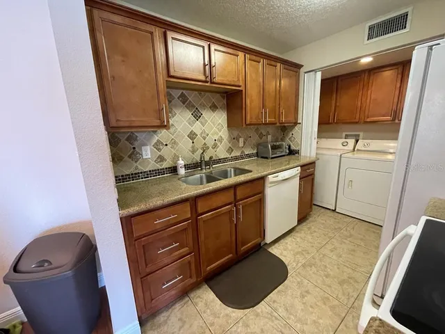 a kitchen with sink cabinets and window