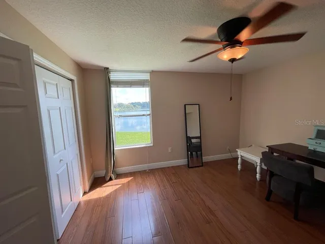 a view of room with window and wooden floor