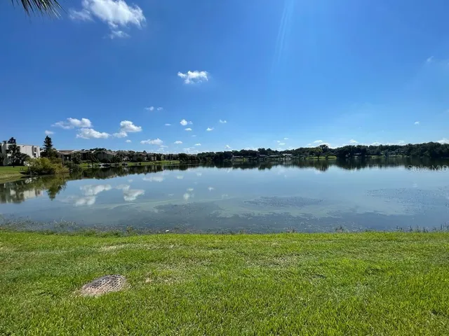 a view of a lake with houses in the back