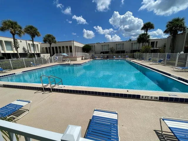 a view of a swimming pool with outdoor seating