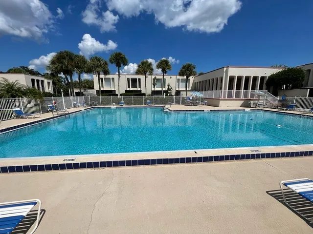 a view of swimming pool with outdoor seating and city view