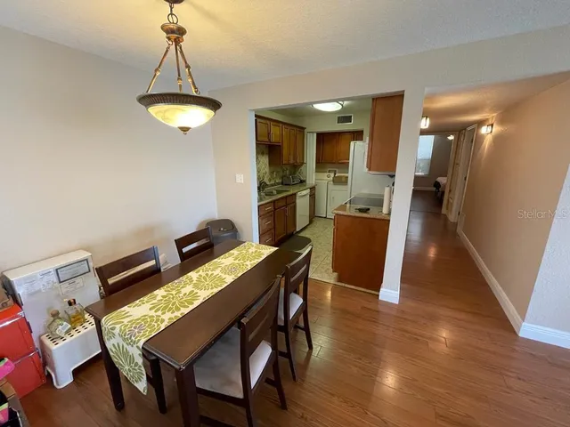 a view of a dining room with furniture and wooden floor