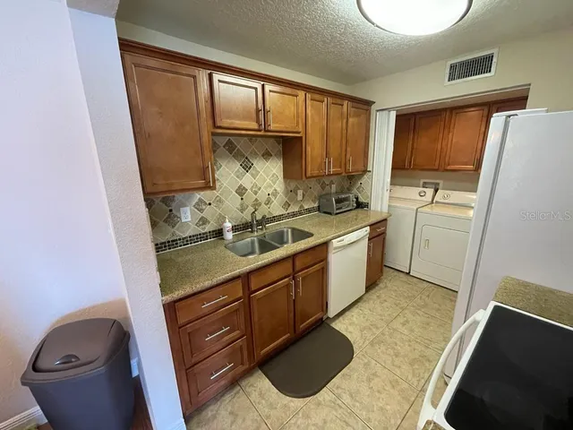a kitchen with sink cabinets and window