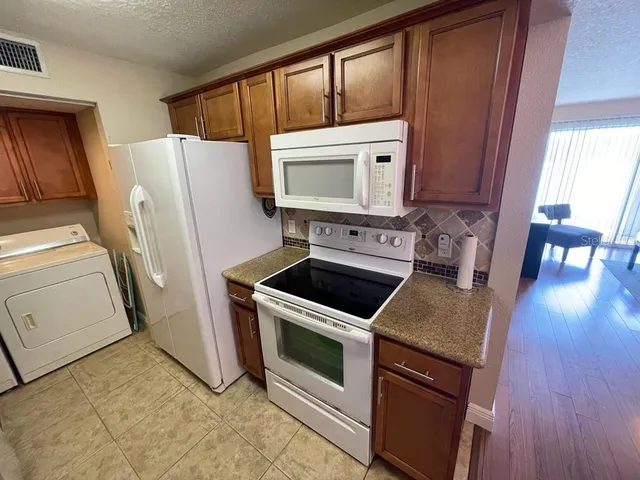 a kitchen with a stove microwave and refrigerator