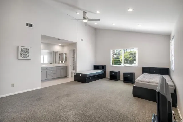 a bathroom with a granite countertop sink a toilet and a mirror