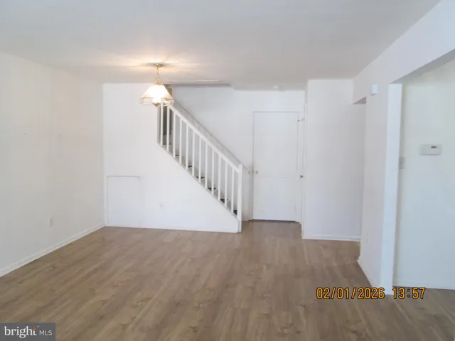 a view of room with stairs and wooden floor