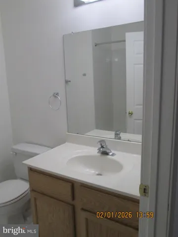 a bathroom with a sink toilet and vanity
