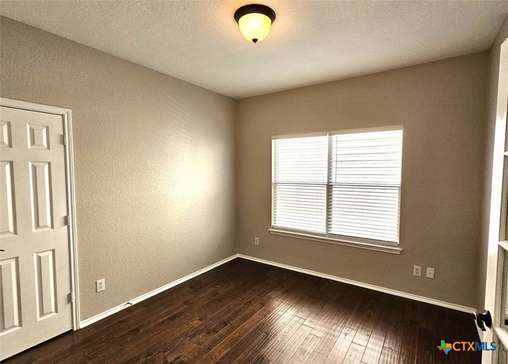 316 Julian Point Cibolo, TX 78108 - Photo 14 of 28 a view of an empty room with wooden floor and a window