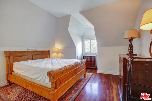 a bed sitting in a bedroom next to a window