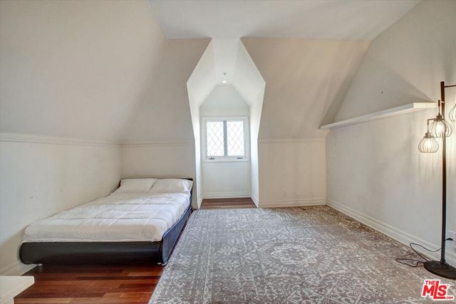 a bedroom with a large bed and furniture